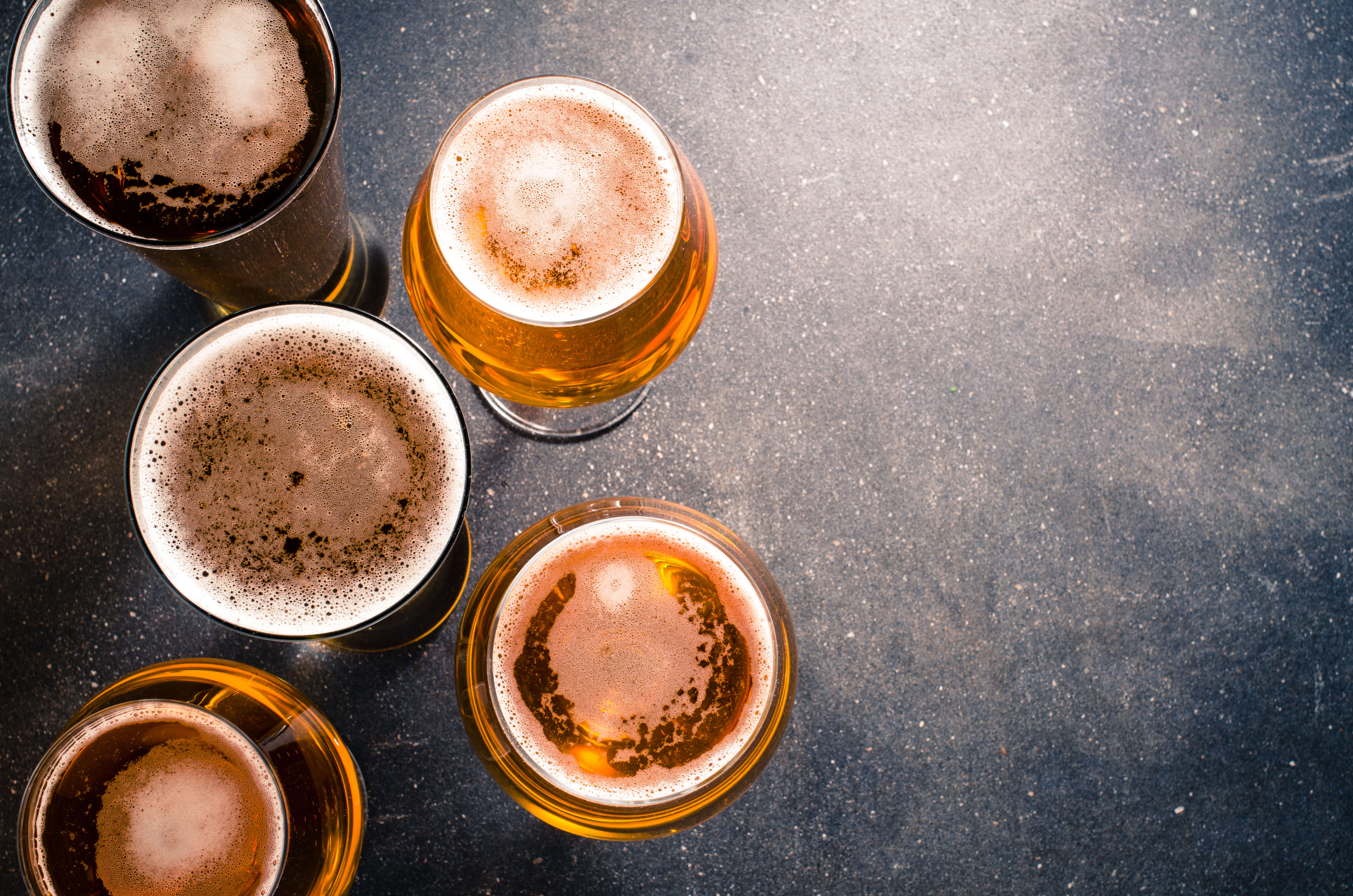 beer glasses on dark table shutterstock 367622336